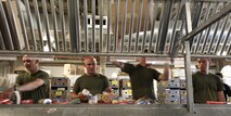 Marines with Company L, 3rd Battalion, 24th Marine Regiment, process and package canned and other sealed goods while it's going by an a conveyor belt - lending a hand at the Great Boston Food Bank May 4, 2010. The Marines are volunteering in support of Marine Week Boston, where they'll provide service to community groups, host physical fitness challenges and sports clinics in city parks and showcase state-of-the-art Marine vehicles, aircraft and equipment.