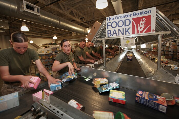Lance Cpl. Eric Carrouth, a native of Boiling Springs, S.C., serving with Company L, 3rd Battalion, 24th Marine Regiment, checks the expiration date on a canned food item as he assists the Great Boston Food Bank May 4, 2010. The Marines are volunteering in support of Marine Week Boston, where they'll provide service to community groups, host physical fitness challenges and sports clinics in city parks and showcase state-of-the-art Marine vehicles, aircraft and equipment.