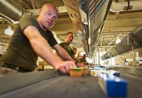 A Marine with Company L, 3rd Battalion, 24th Marine Regiment, gathers sauces and condiments into a package while lending a hand to the Greater Boston Food Bank May 4, 2010. The Marines are volunteering in support of Marine Week Boston, where they'll provide service to community groups, host physical fitness challenges and sports clinics in city parks and showcase state-of-the-art Marine vehicles, aircraft and equipment.