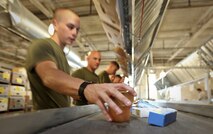 A Marine with Company L, 3rd Battalion, 24th Marine Regiment, waits for specific items that he's responsible for packaging while providing volunteer service to the Greater Boston Food Bank May 4, 2010. The Marines are volunteering in support of Marine Week Boston, where they'll provide service to community groups, host physical fitness challenges and sports clinics in city parks and showcase state-of-the-art Marine vehicles, aircraft and equipment.