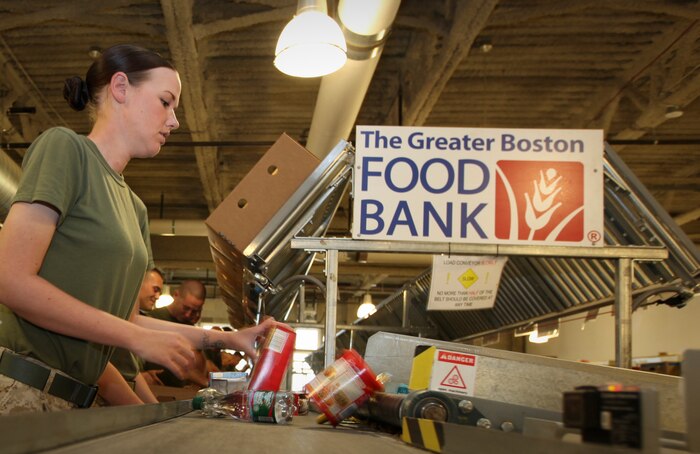 A Marine with Company L, 3rd Battalion, 24th Marine Regiment, puts together a package of snack foods while providing volunteer service to the Greater Boston Food Bank May 4, 2010. The Marines are volunteering in support of Marine Week Boston, where they'll provide service to community groups, host physical fitness challenges and sports clinics in city parks and showcase state-of-the-art Marine vehicles, aircraft and equipment.