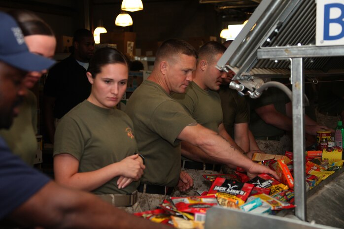 Marines with Company L, 3rd Battalion, 24th Marine Regiment, based in Johnson City, Tenn., sort food on a conveyer belt in the Greater Boston Food Bank in Boston May 4, 2010. Details like expiration dates and the state of the packaging affect whether or not the food bank can distribute the goods to the people that need them.