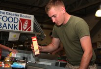 Cpl. Seth Lane, a rifleman with Company L, 3rd Battalion, 24th Marine Regiment, and a Big Stone Gap, Va., native, places food containers for Marines in his company to sort on a conveyer belt in the Greater Boston Food Bank in Boston May 4, 2010. This was one of approximately 20 volunteer events Marines will participate in for Marine Week Boston.