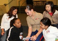 Corporal Erin Carpenter, a disbursing clerk with Marine Forces Reserve, participates in a leadership exercise with members of the Boys and Girls Club, May 4, 2010. Four female Marines from various units throughout the Marine Corps volunteered to share their personal stories of endurance and success with the young girls in support of Marine Week Boston, May 3-9.