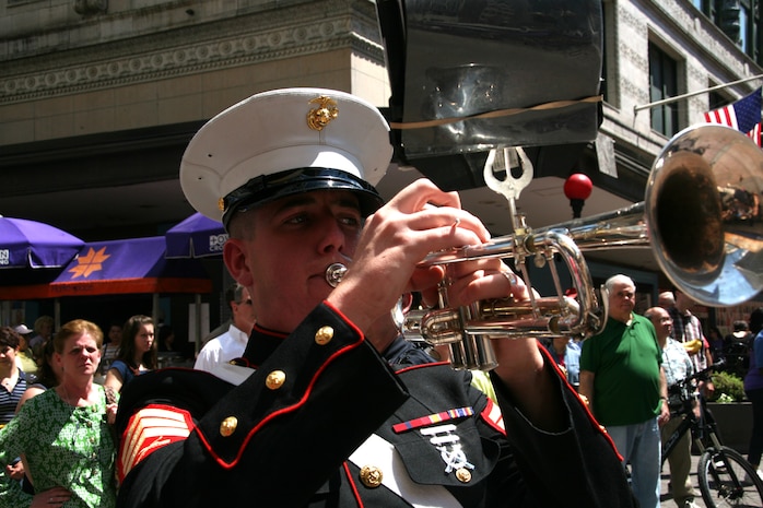 Sgt. William M. Merritt, a trumpet player for Albany Marine Band and native of Jacksonville, Fla., plays his trumpet during ''Stars and Stripes,''in downtown Boston, Mass., in a crowd of surrounding Bostonians, May 4, 2010. Albany Marine Band performed several songs to include, ''Stars and Stripes, Marines' Hymn, What a Wonderful World and Semper Fi.''? The band's performance played a key role in Marine Week Boston to share the Corps' traditions, history and culture with Bostonians and help them learn about the Corps' value to the nation.