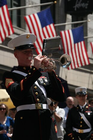 Sgt. Bryant M. Luciano, a trumpet player for Albany Marine Band and native of Pensacola, Fla., plays his trumpet during a solo performance, ''Georgia,'' in downtown Boston, Mass., in a crowd of surrounding Bostonians, May 4, 2010. Albany Marine Band performed several songs to include, ''Stars and Stripes, Marines' Hymn, What a Wonderful World and Semper Fi.'' The band's performance played a key role in Marine Week Boston to share the Corps' traditions, history and culture with Bostonians and help them learn about the Corps' value to the nation.