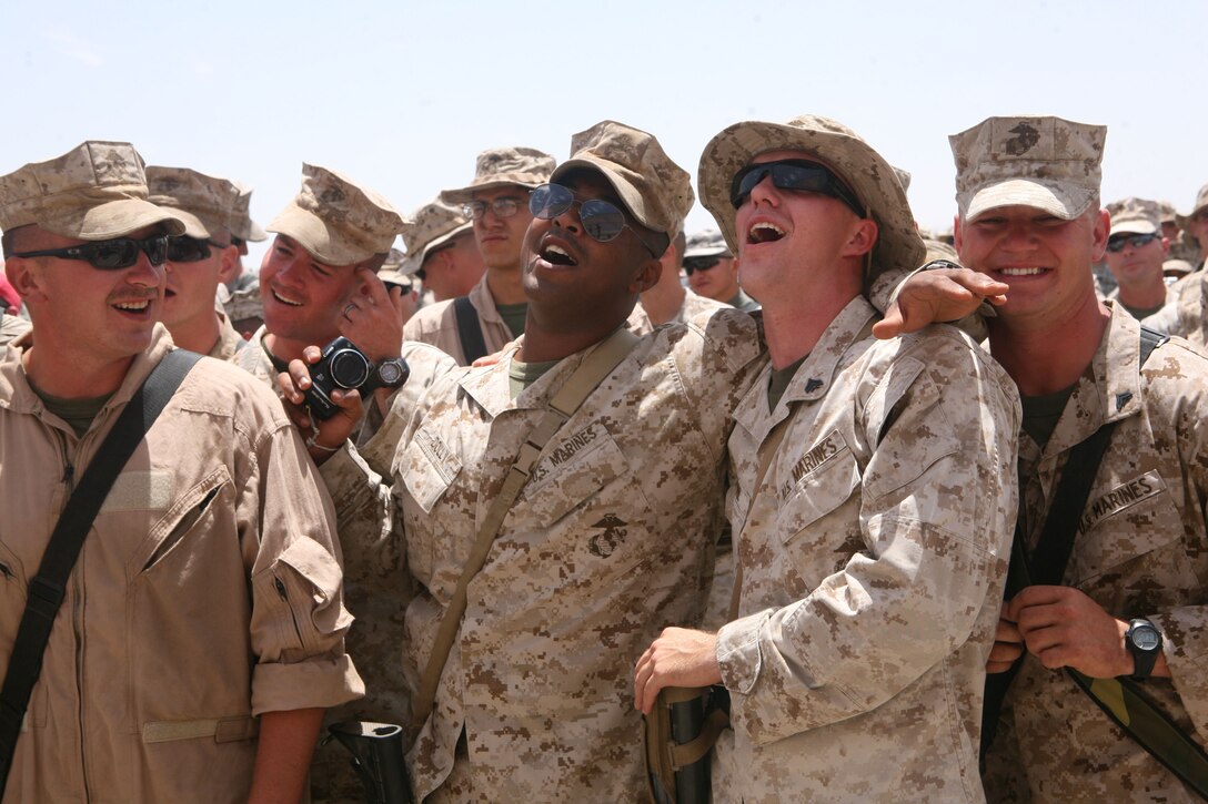 Lance Cpl. Alex Dolly and Cpl. Michael Stone sing along during the Toby Keith USO concert at Camp Dwyer, Helmand province, Afghanistan, May 6. More than 500 Marines, sailors, soldiers and airmen attended the first USO concert held at Camp Dwyer.