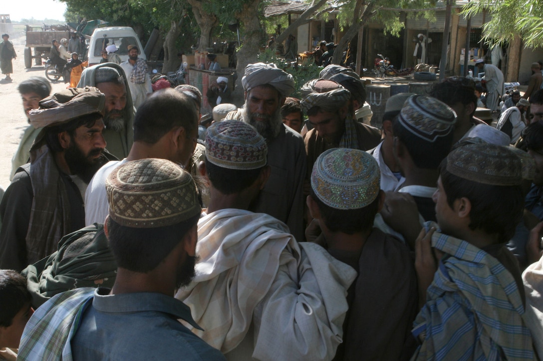 A group of men gather in the Koru Chareh Bazaar in Marjah, Afghanistan, May 5. Since the initial fighting to take the city, residents have returned to their homes and the marketplace, the hub of the community, has reopened.