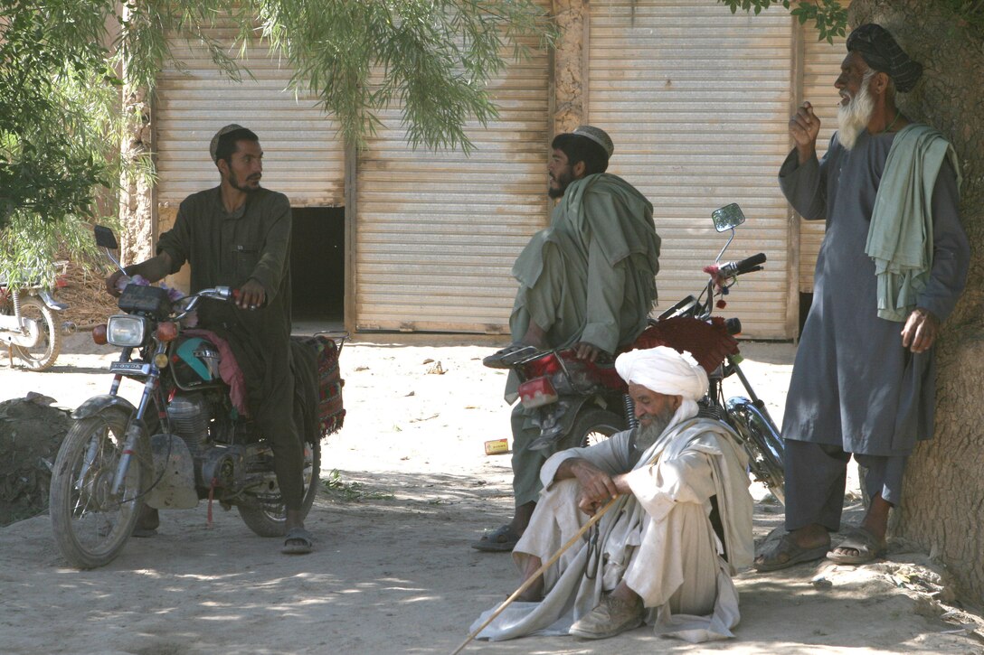 A group of men rest in the shade in the Koru Chareh Bazaar in Marjah, Afghanistan, May 5. Since the initial fighting to take the city, residents have returned to their homes and the marketplace, the hub of the community, has reopened.