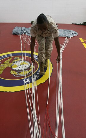 Staff Sgt. Jacquelyn Samuel, an air delivery specialist with Landing Support Company, Combat Logistics Regiment 27, 2nd Marine Logistics Group, packs a multi-mission capable parachute aboard Camp Lejeune, N.C., May 5, 2010. Samuel became the first female Marine to attend the U.S. Army High-Altitude, Low-Opening parachutist course in August 2008.