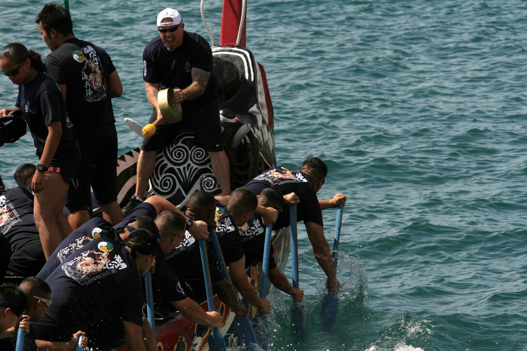 Randy Mitchell, one of the coaches for the Single Marine Program’s Dragon Boat Team, beats a drum to maintain cadence at the annual Naha Haarii Dragon Boat Races May 5. This was the first time the entire team had rowed together.