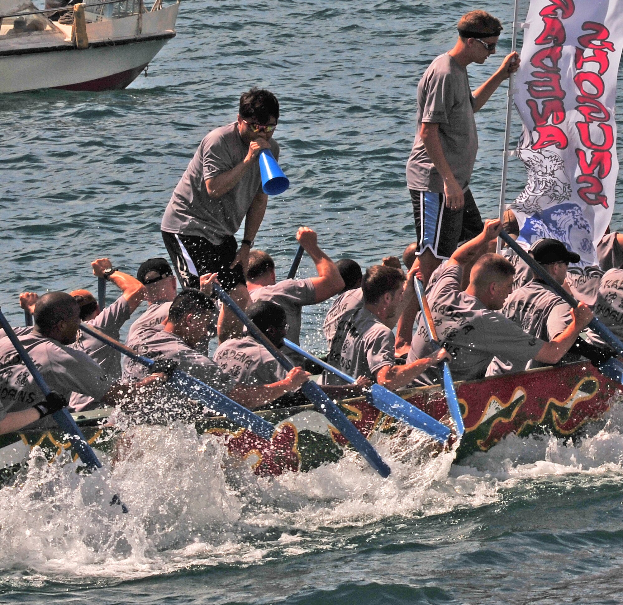 Hideaki Sakihama, 18th Wing public affairs community relations specialist, "motivates" the Kadena Shoguns men's team during the 36th Annual Naha Dragon Boat Races in Naha City May 5. The men's team came out on top with the fastest time of all U.S. military teams and finished second in a close heat against the Naha Fire Department and U.S. Marine Corps teams. The Kadena women's team finished second in their heat against two local corporations, as well as second overall for U.S. military teams. Visit Kadena's Flickr page for more photos. (Air Force/Staff Sgt. Jason Lake)