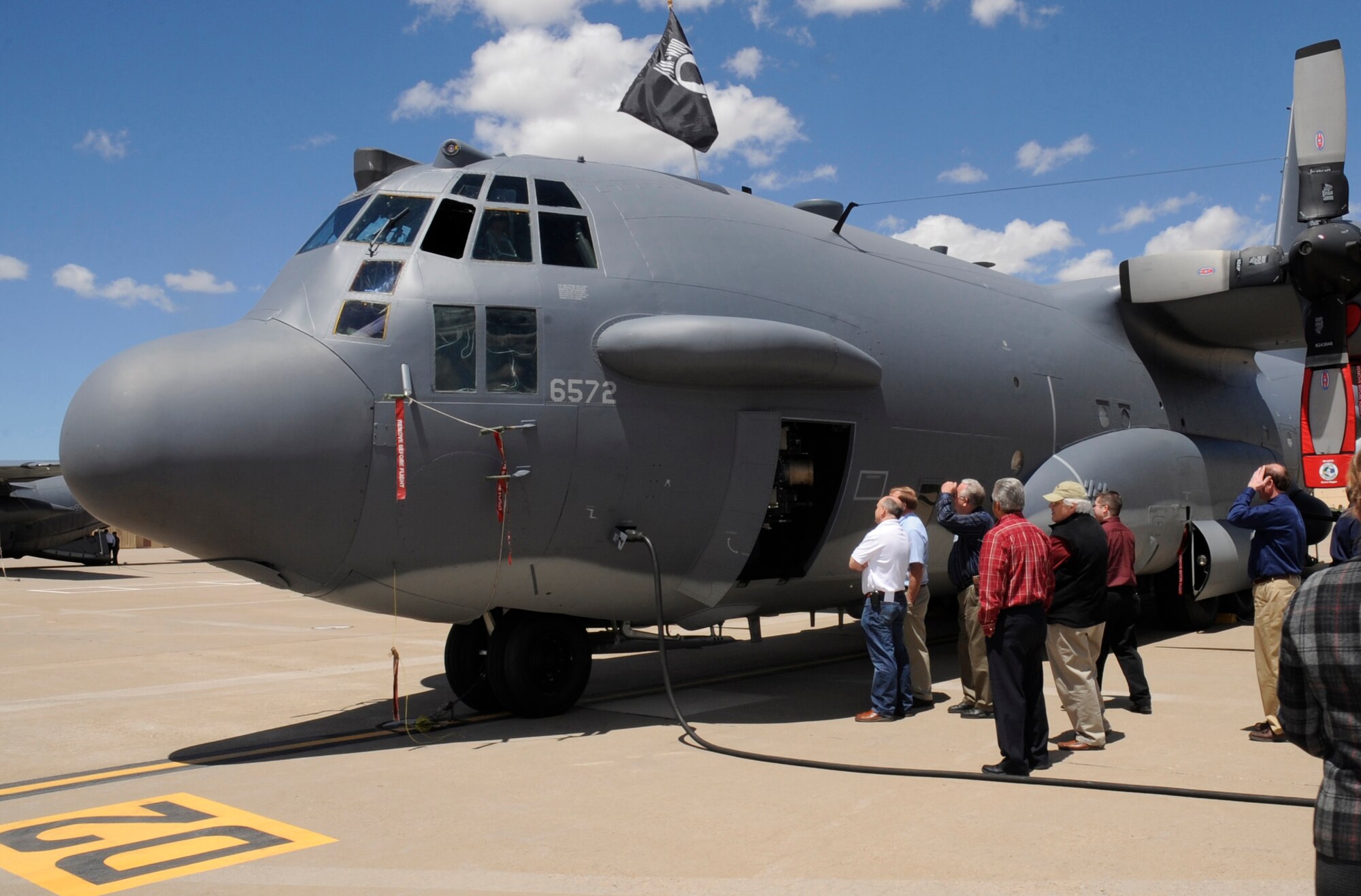 Clovis and Portales civic leaders look at an AC-130H Spectre Gunship during a tour at Cannon Air Force Base May 3. The event included a briefing from the wing commander, Col. Stephen Clark, a tour of key base buildings, lunch at the Pecos Trail dining facility, static aircraft displays, and a driving tour of the base. (U.S. Air Force Photo by Senior Airman Evelyn Chavez)