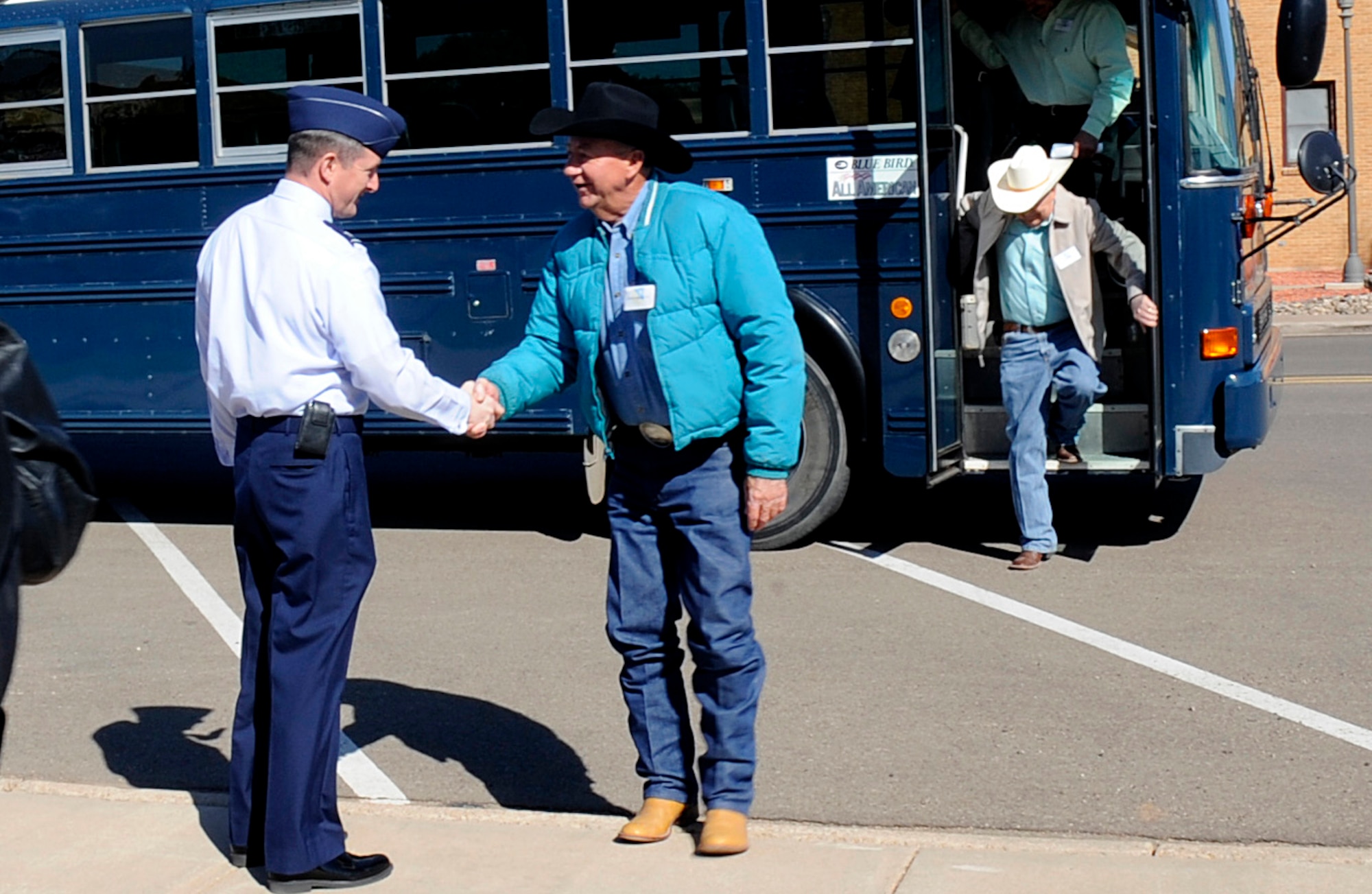 Gene Creighton, Roosevelt County commissioner, shakes hands with Col. Stephen Clark, 27th Special Operations Wing commander, during a Civic Leaders tour at Cannon Air Force base May 3. Twenty-four Clovis and Portales community leaders participated in the event that included a brief by the commander, a tour of key base buildings, lunch at the Pecos Trail Dining Facility, static aircraft displays, and a driving tour of the base. (U.S. Air Force Photo by Senior Airman Evelyn Chavez)