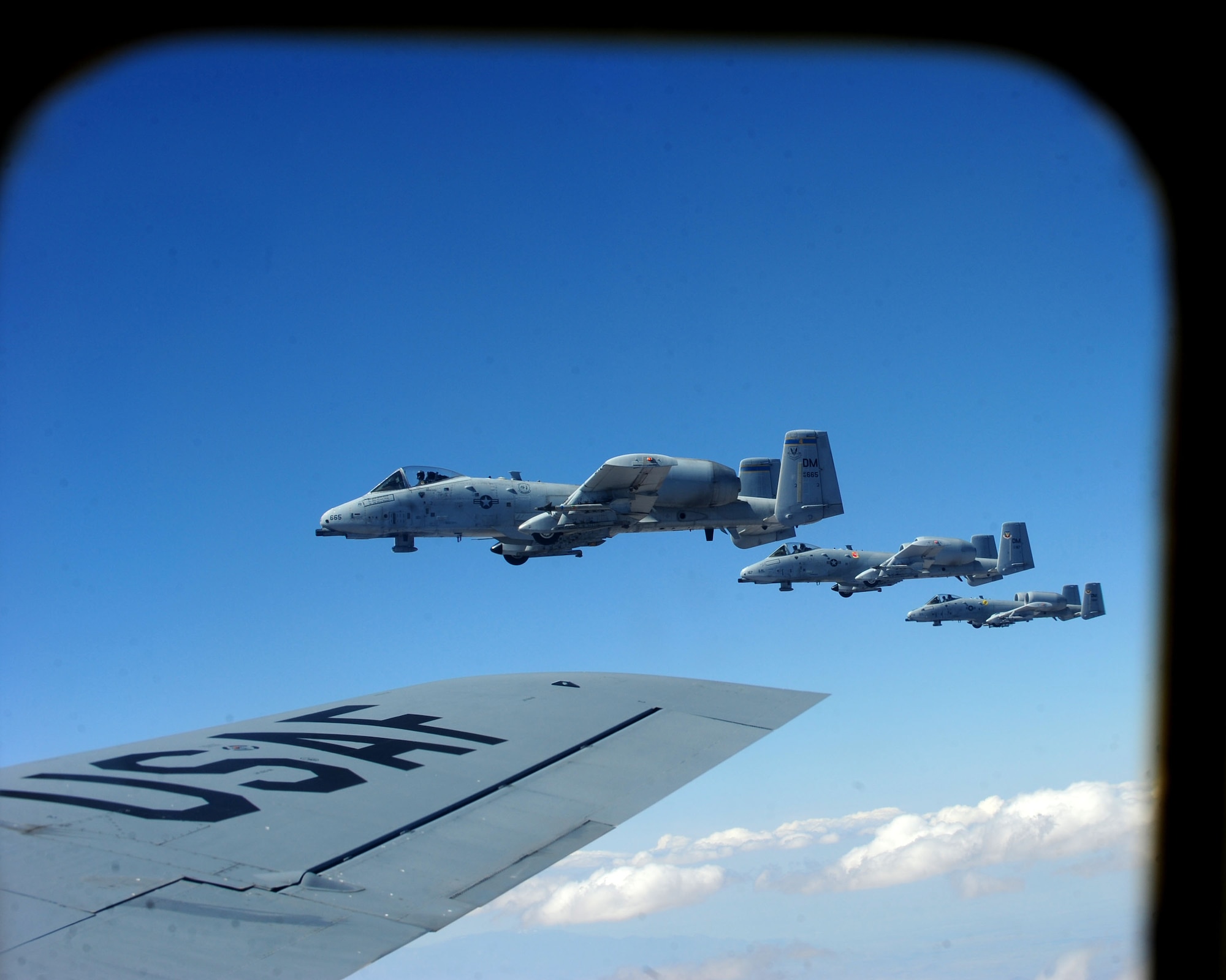 Three A-10C Thunderbolt IIs fly in formation beside a KC-135 Stratotanker April 27, 2010, during an aerial refueling mission over Southern Arizona. The pilots, from the 358th Fighter Squadron at Davis-Monthan Air Force Base, Ariz., completed their first aerial refueling mission as part of their training to become fully qualified A-10C attack pilots. (U.S. Air Force photo/Airman Jerilyn Quintanilla)