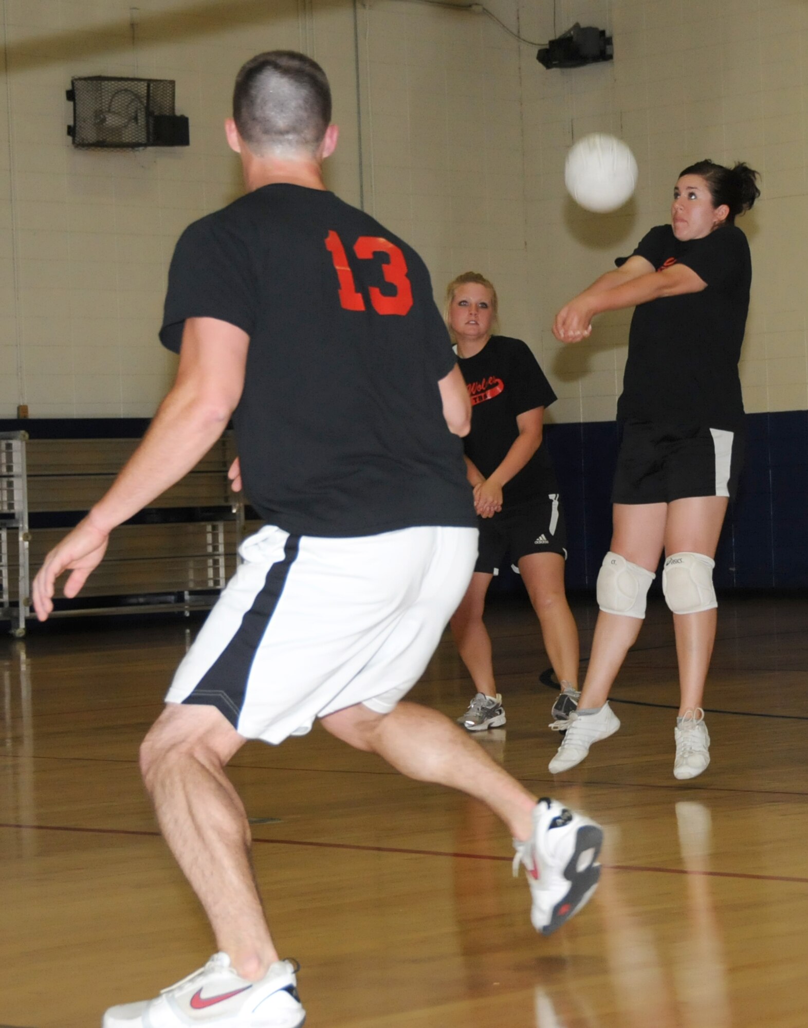 From left, Michael Smith and Brooke Morin get ready as Erika Avers returns a serve for the 336th TRS-B during the intramural volleyball finals.  (U.S. Air Force photo by Kemberly Groue)