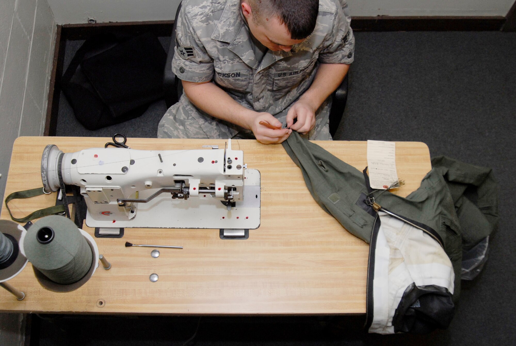 Senior Airman Michael Jackson uses a sewing machine to replace the wrist seals on an anti-exposure flyers overall April 7, 2010, at Kunsan Air Base, South Korea. Airman Tanner is an aircrew flight equipment craftsman assigned to the 8th Operations Support Squadron. (U.S. Air Force photo/Staff Sgt. Darnell T. Cannady) 