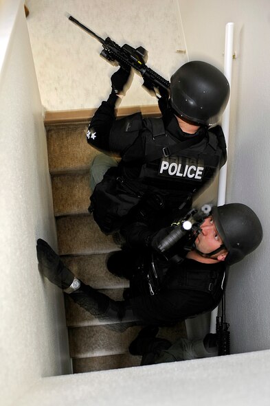 ELLSWORTH AIR FORCE BASE, S.D. -- Police officers clear a stairway during a basic SWAT team training exercise, May 4. The 28th Security Forces Squadron opened two vacant houses on base for the training. (U.S. Air Force photo/Airman 1st Class Matthew Flynn)