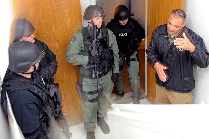 ELLSWORTH AIR FORCE BASE, S.D. – (Right) Mark Neal, Fort Collins, Colo. Police Department police officer, provides feedback to participants of a basic SWAT team training exercise, May 4.  SWAT is an elite special operations tactical unit, trained to perform high-risk operations that fall outside the abilities of regular patrol officers. (U.S. Air Force photo/Airman 1st Class Matthew Flynn)