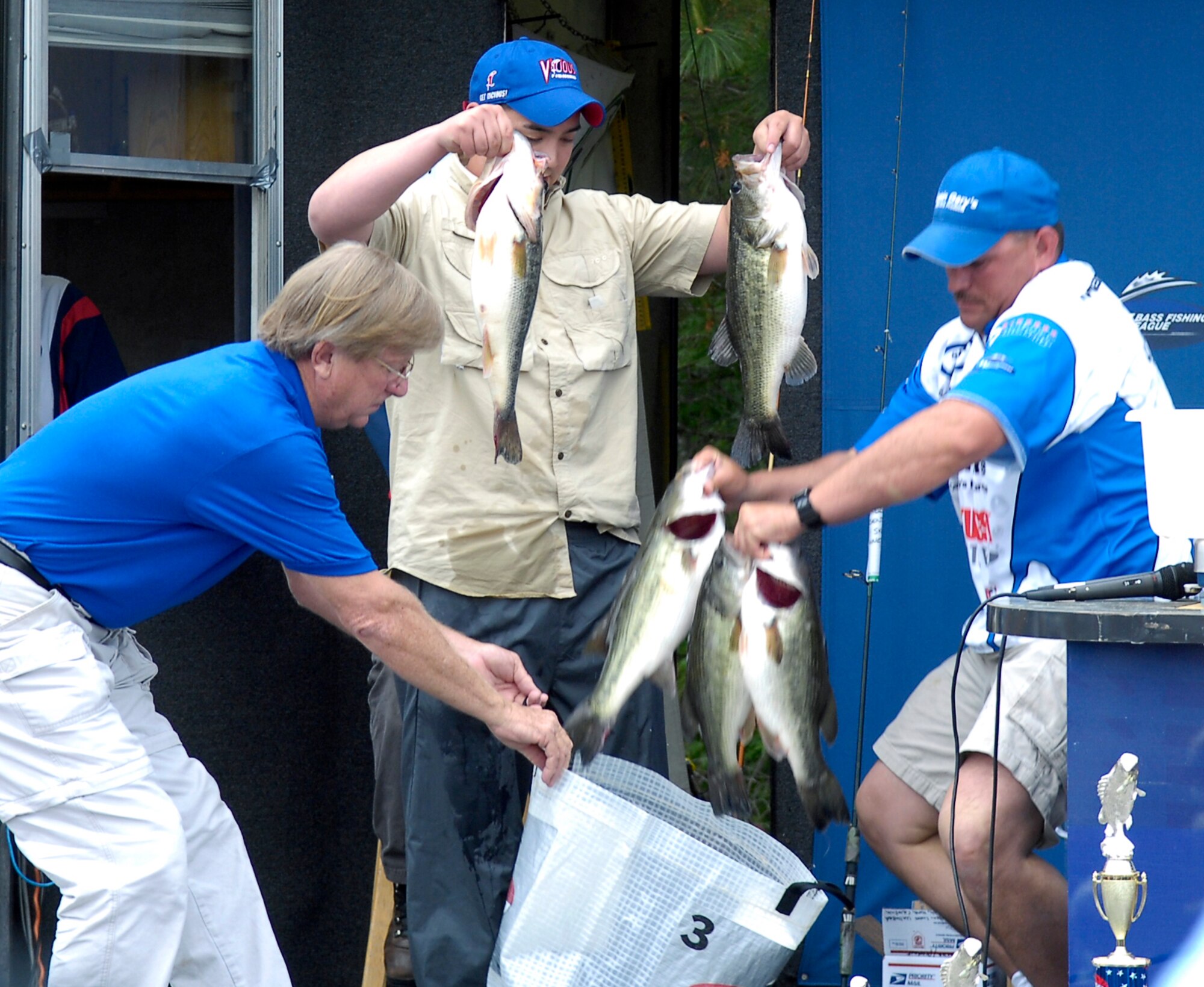 Tech. Sgt. James Poirrier (right), 43rd Logistics Readiness Squadron, and his co-angler, Army Staff Sgt. Parker Tootill, prepare their fish for weighing during the closing ceremony of the fifth annual Warriors on the Water fishing tournament. The pair took 1st place with a combined weight of 21 pounds, three ounces of fish. (U.S. Air Force photo/Senior Airman Kris Levasseur)