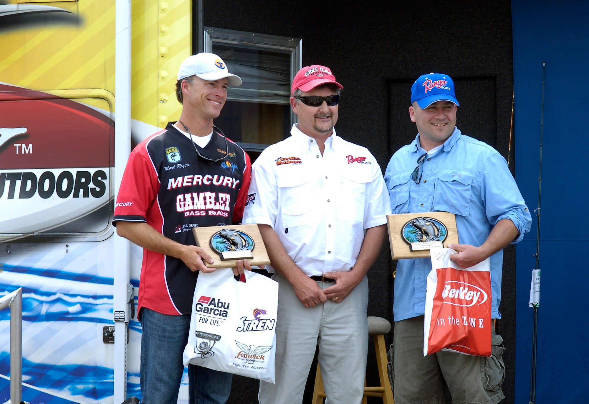 Tech. Sgt. Steven Thackery, 43rd Aeromedical Evacuation Squadron and his boater, Mark Rogers receive the Tech. Sgt. David G. Roberson II Big Bass Trophy for one of their fish that weighed in at seven pounds, six ounces. Sergeant Roberson was an avid fisherman and proud supporter of the Warriors on the Water who passed away unexpectedly Dec. 27, 2009. This year’s ‘Big Bass trophy’ was named in his honor. (U.S. Air Force photo/Senior Airman Kris Levasseur)