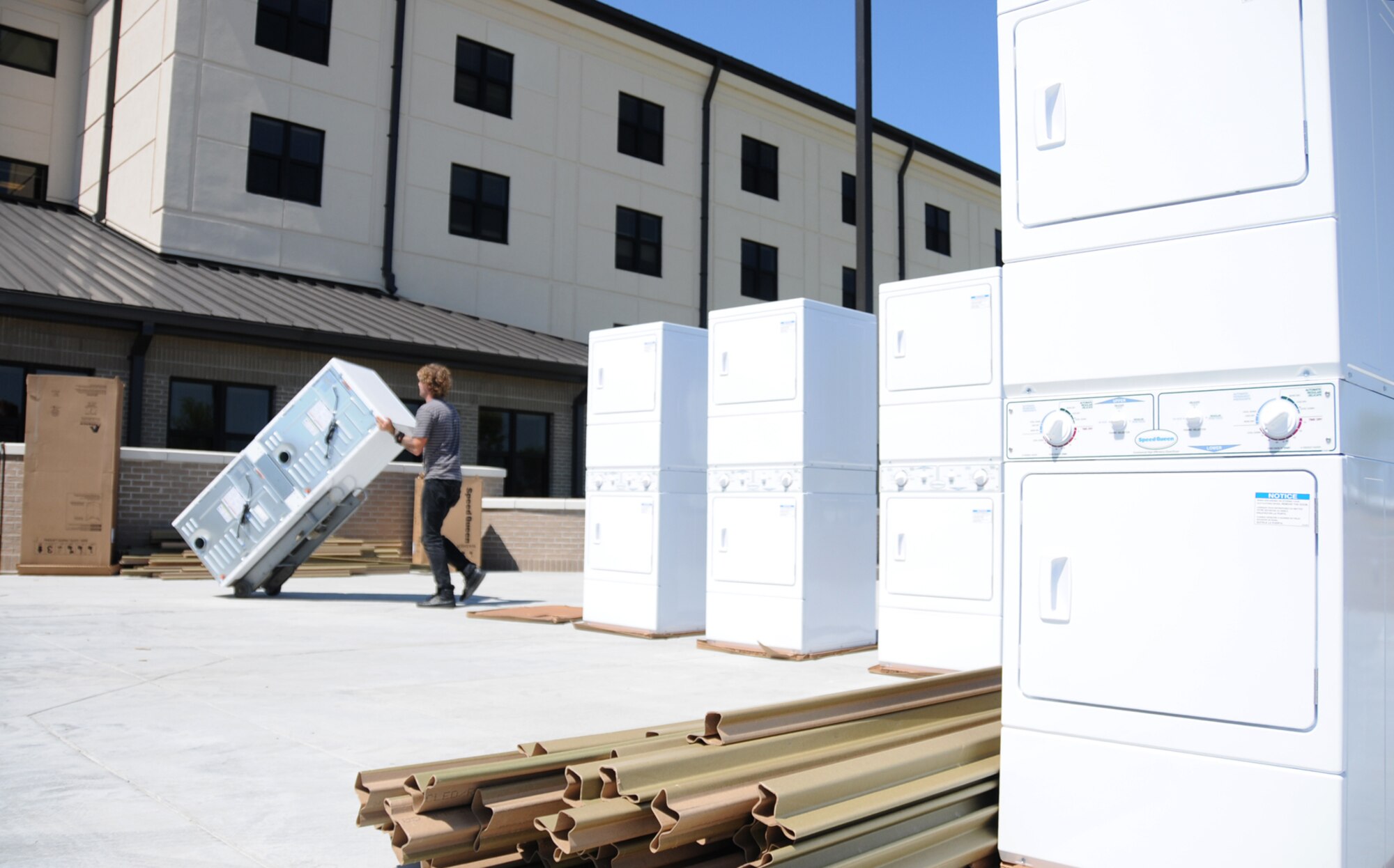 Franklin Smith from P&M Appliance in Pensacola, Fla., moves stacked washer/dryer sets into the 81st Training Group’s ninth new dormitory for nonprior service students April 28.  Students from the 334th Training Squadron begin moving into Avery Manor Saturday.  The ribbon-cutting ceremony is planned for 10:30 a.m. June 1.  (U.S. Air Force photo by Kemberly Groue)