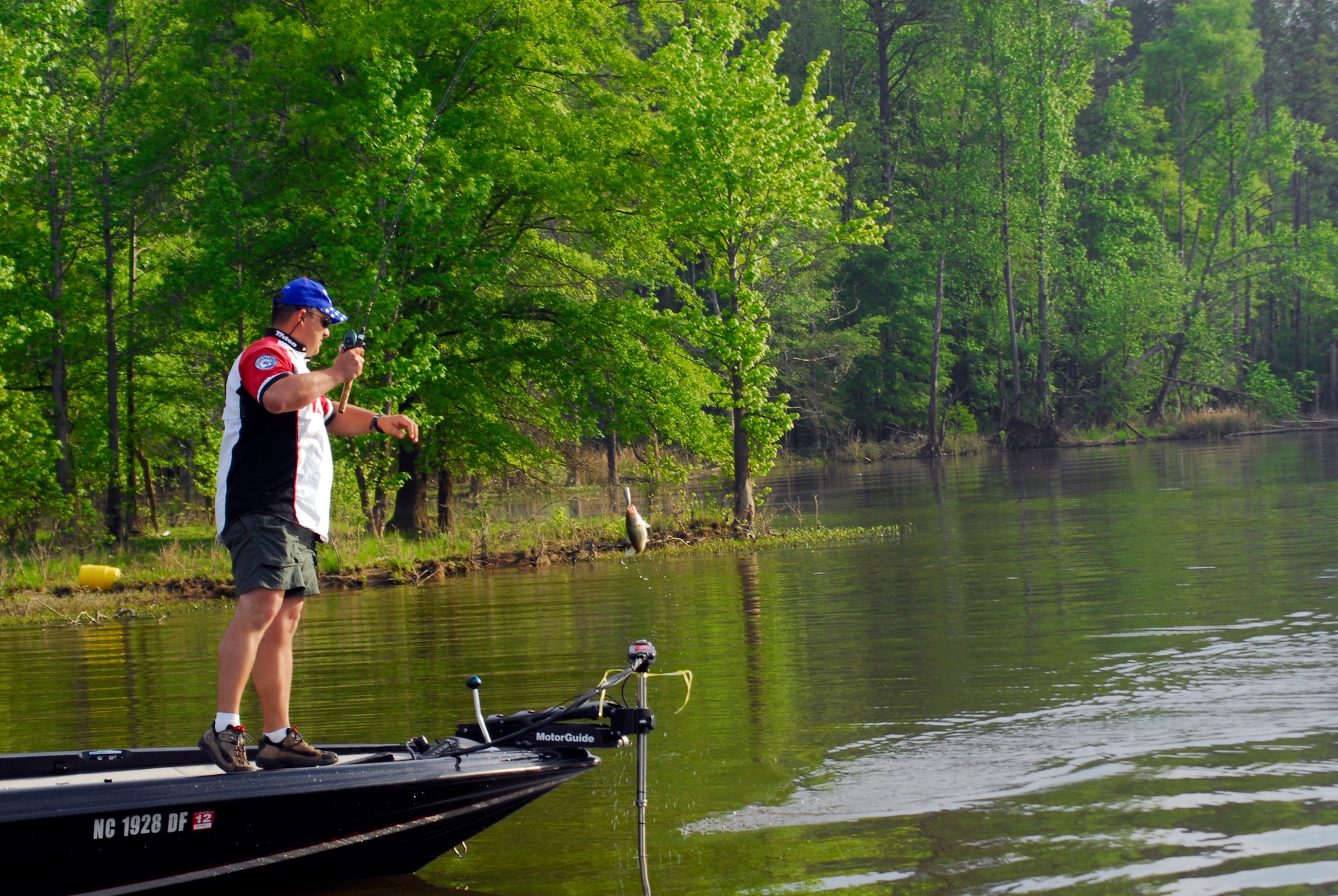 A fisherman pulls in his first catch of the day on Jordan Lake in Raleigh N.C. during the fifth annual Warriors on the Water fishing tournament April 23. The tournament’s more than 300 participants caught more than 200 fish weighing approximately 690 pounds. (U.S. Air Force photo/Senior Airman Quentin Irvin)