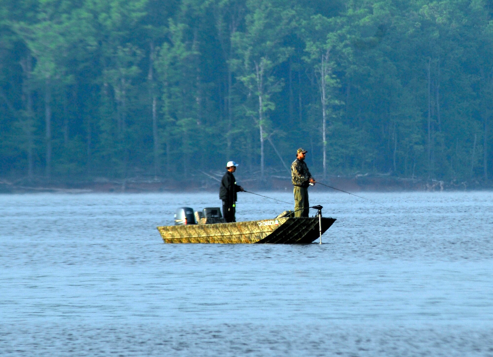 A boater and an angler set their lures in the water on Jordan Lake in Raleigh N.C. during the fifth annual Warriors on the Water fishing tournament April 23. More than 150 Airmen, Soldiers, Marines and Sailors from military installations across the country were pared up with an expert fisherman who would act as the angler for the day while the service member acted as co-angler. (U.S. Air Force photo/Senior Airman Quentin Irvin)