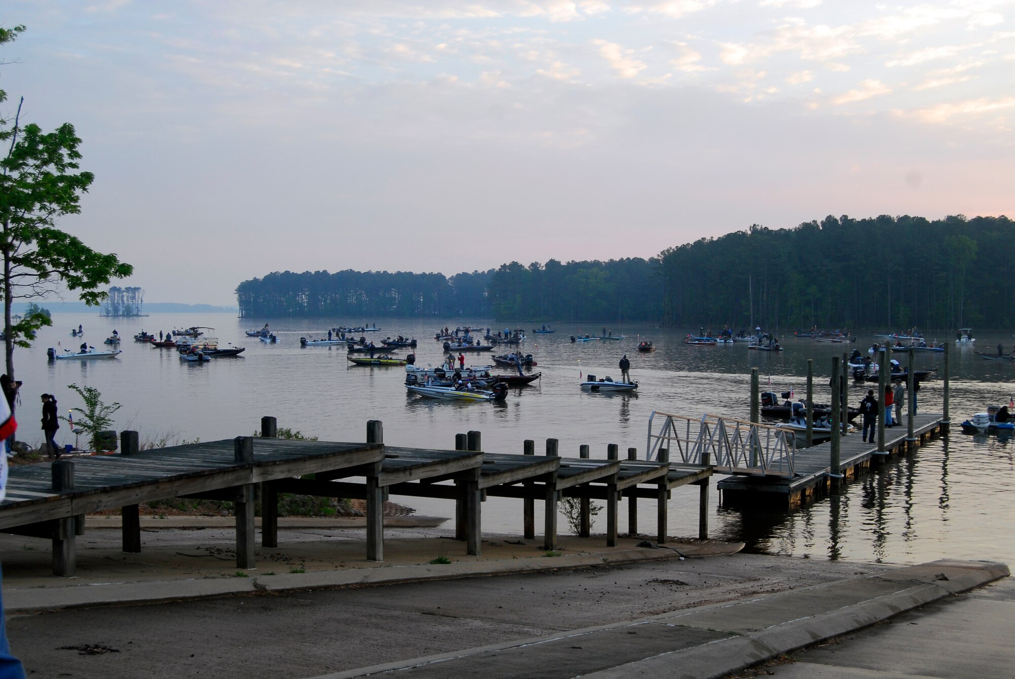Hundreds of boats gather near the New Hope Outlook boat ramp on Jordan Lake in Raleigh N.C. to view an Army aerial demonstration by the Golden Knights during the opening ceremony of the fifth annual Warriors on the Water fishing tournament. Warriors on the Water is a fast-growing tradition among service members where Airmen, Soldiers, Marines and Sailors are given food, supplies and a seat on a boat with an experienced fisherman all at no cost to the service member. (U.S. Air Force photo/Senior Airman Quentin Irvin) 