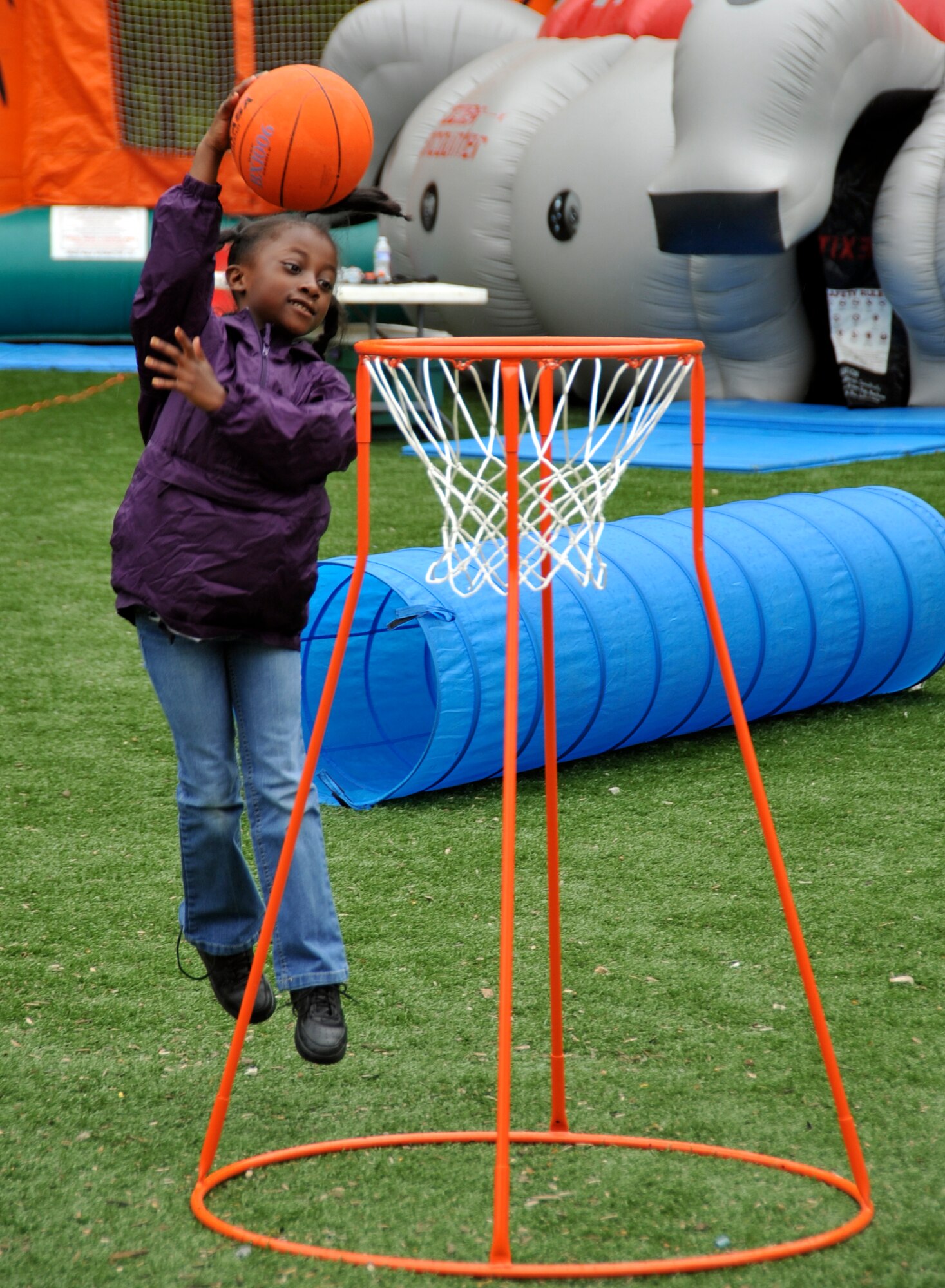 Bryanna Huger, 7, slam dunks her basketball through a portable hoop used as part of an obstacle course during the FitFactor portion of Family Fest at the Andrews Youth Center at Joint Base Andrews, Md., April 24, 2010. Bryanna is the daughter of Airman 1st Class Tiffany Huger, 779th Medical Operation Squadron ophthalmology admin.