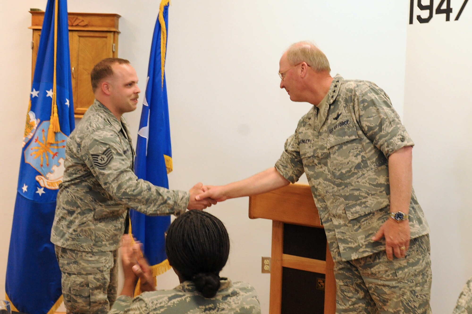 The National Guard Bureau Chief, Gen. Craig R. McKinley presents US Air Force Tech. Sgt. Michael Griepsma with a coin for outstanding work as a Ground Radio technician at Hancock Field in Syracuse NY on 5 May 2010. McKinley was meeting with members of the New York Air and Army guard at a luncheon to recognize the efforts of the men and women of these organizations. (US Air Force photo by Tech. Sgt. Jeremy M. Call/Released)