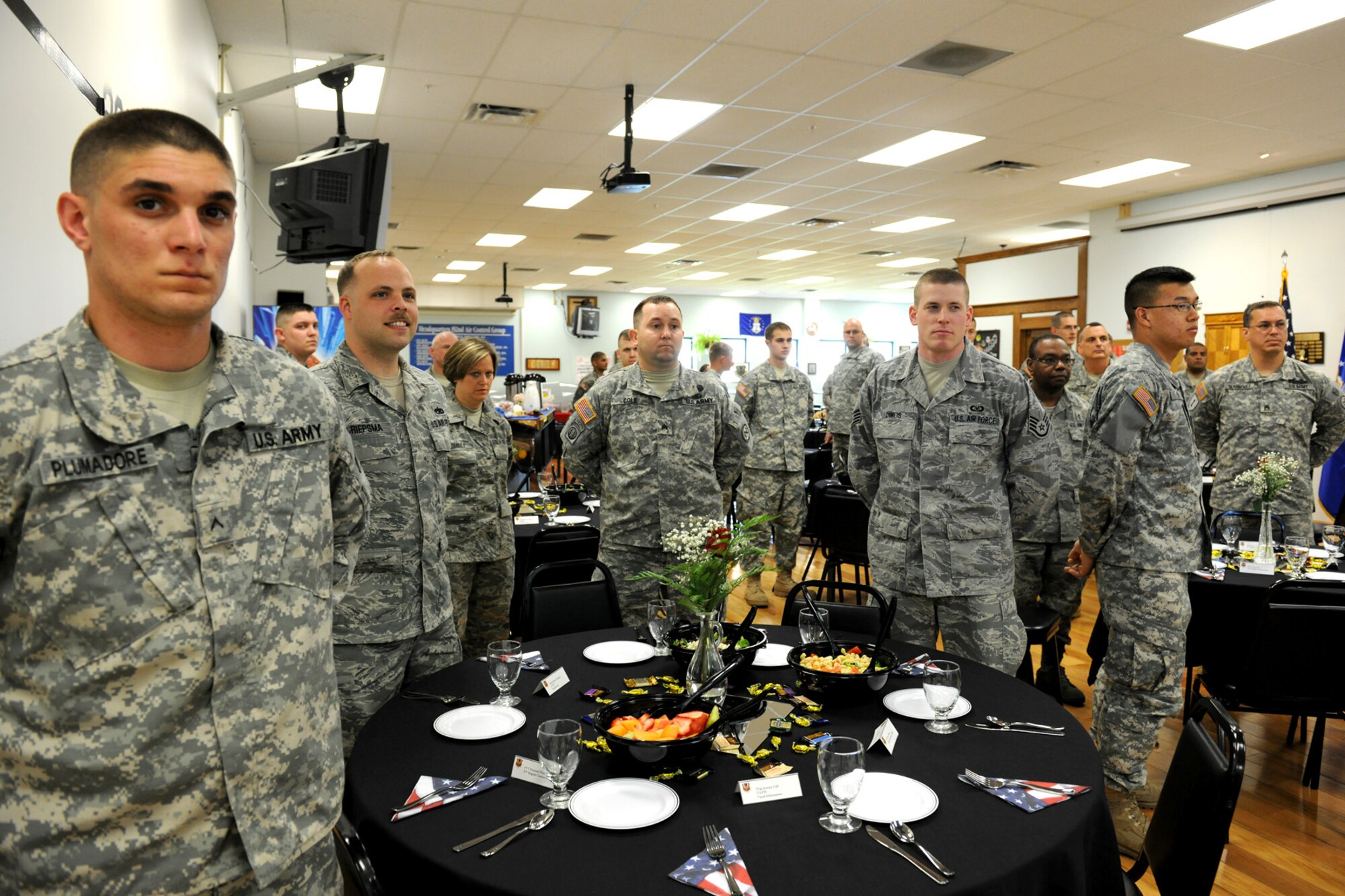 Members of the New York Air National Guard's 174th Fighter Wing and members of the New York Army National Guard's 27th Brigade await the arrival of the National Guard Bureau Chief, Gen. Craig R. McKinley at Hancock Field in Syracuse NY on 5 May 2010. McKinley was meeting with members of the New York Air and Army guard at a luncheon to recognize the efforts of the men and women of these organizations. (US Air Force photo by Tech. Sgt. Jeremy M. Call/Released)