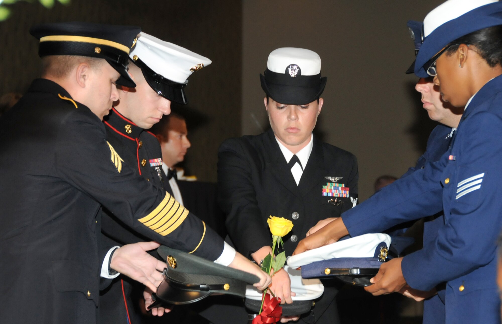 From left, Sgt. Christian Friedman, U.S. Army Recruiting Command; Sgt. Geoffrey Donahue, Keesler Marine Corps Detachment; Aerographer’s Mate 2nd Class Nadine Reif, Keesler Center for Naval Aviation Technical Training Unit; Staff Sgt. Michael Shema, 335th Training Squadron, and Seaman Stephanye Aldridge from the Coast Guard Station, Gulfport, participate in the POW/MIA ceremony at the 81st Training Group dining out, Friday at the Mississippi Coast Coliseum Convention Center, Biloxi.  (U.S. Air Force Photo by Kemberly Groue)