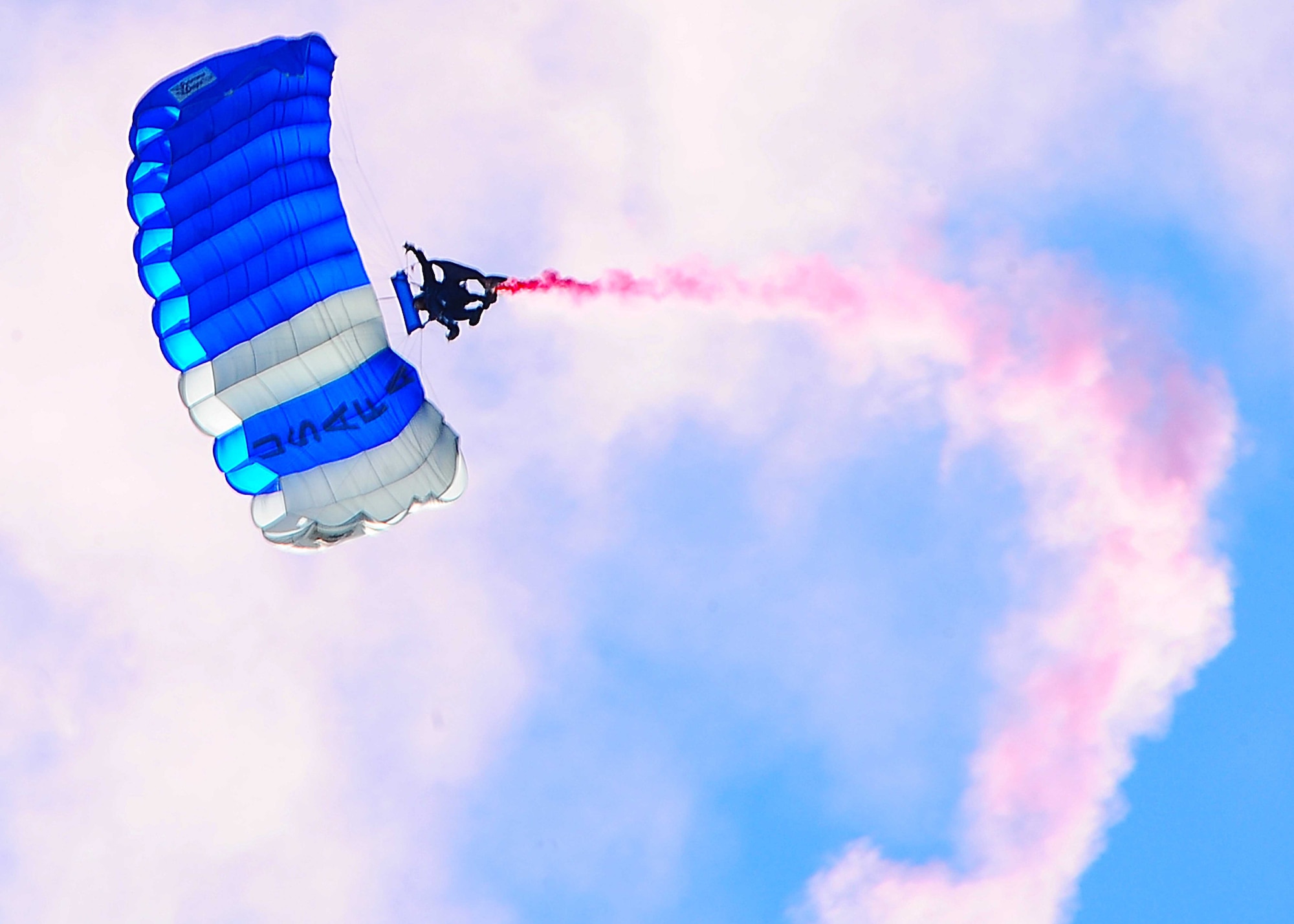 DYESS AIR FORCE BASE, Texas -- A U.S. Air Force Academy "Wings of Blue" parachute demonstration team member performs parachute maneuvers during the Rockin' in the Park festival April 30 at the parade grounds here. During the festival, hundreds of members from Dyess came together for camaraderie and entertainment. There was live music and several buffet lines of Texas Barbecue. The event is held each year the day before the airshow. (U.S. Air Force photo/Senior Airman Stephen Reyes)
