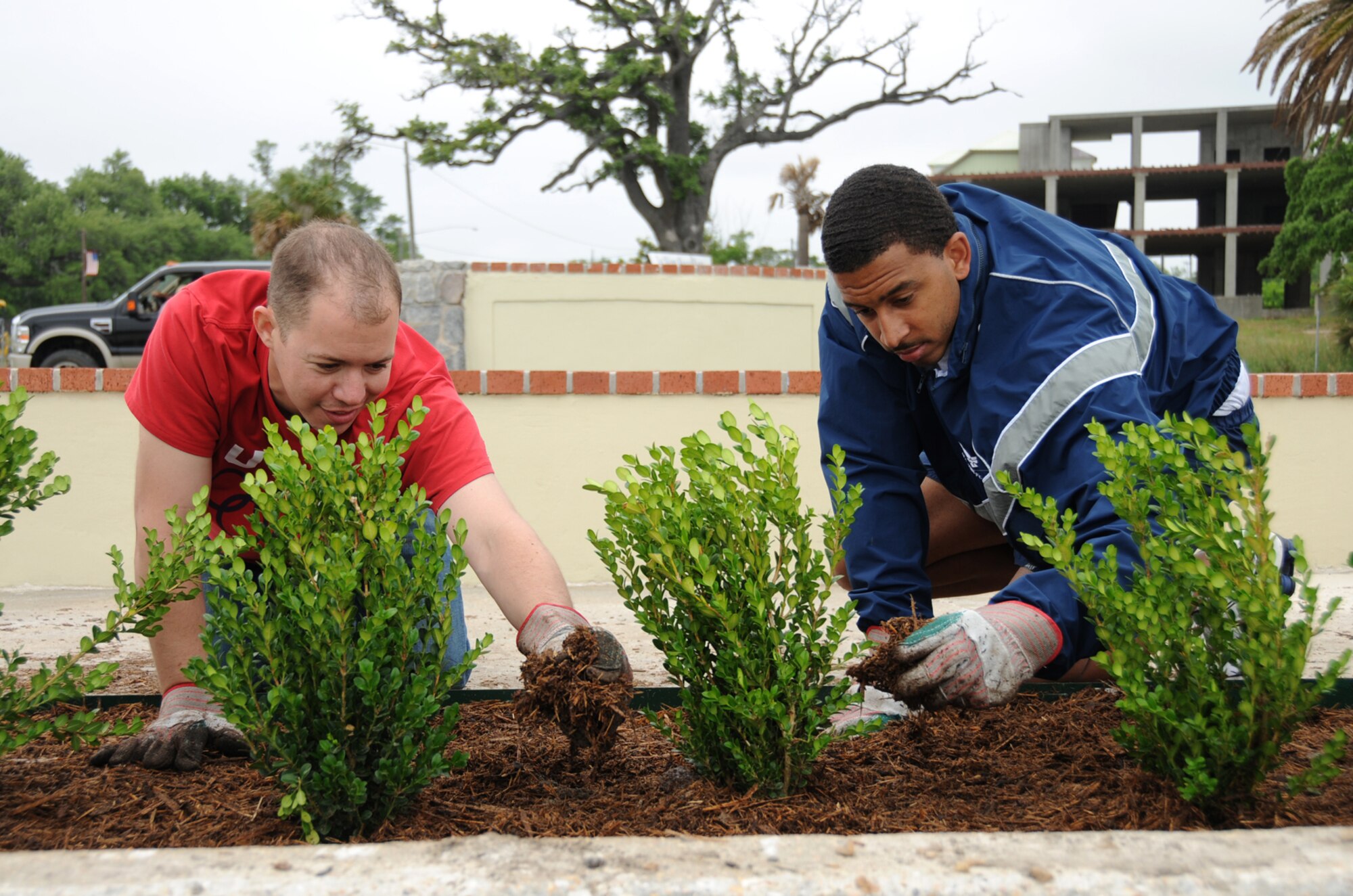 Second Lt. Eric Krispin, left, and Staff Sgt. Cliff Thompson are part of a team of students and instructors from the 333rd Training Squadron that landscaped the area around a refurbished fountain in the median of U.S. Highway 90 in Biloxi near the White Avenue entrance to Keesler. (U.S. Air Force Photo by Kemberly Groue)