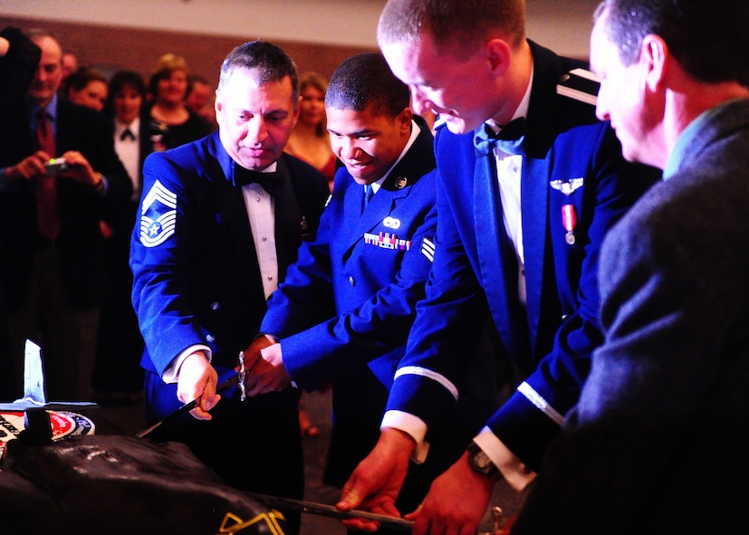 ABILENE, Texas -- Members of Dyess Air Force Base cut the B-1Bomber model cake April 30 during the 25th Anniversary Banquet celebrating the delivery of the first B-1 to Dyess at the Abilene Civic Center. During the event there was live music form the Abilene Christian University jazz band and Lytle Land and Cattle catered the event. Members nationwide came to support the event. (U.S. Air Force photo/Senior Airman Stephen Reyes)
