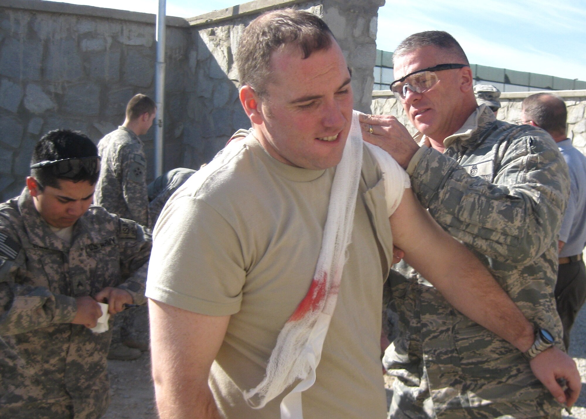 Sergeant Gestring, right, provides treatment to wounded coalition forces and Afghan National Police after the Jan. 6 attack.  (Courtesy photo)