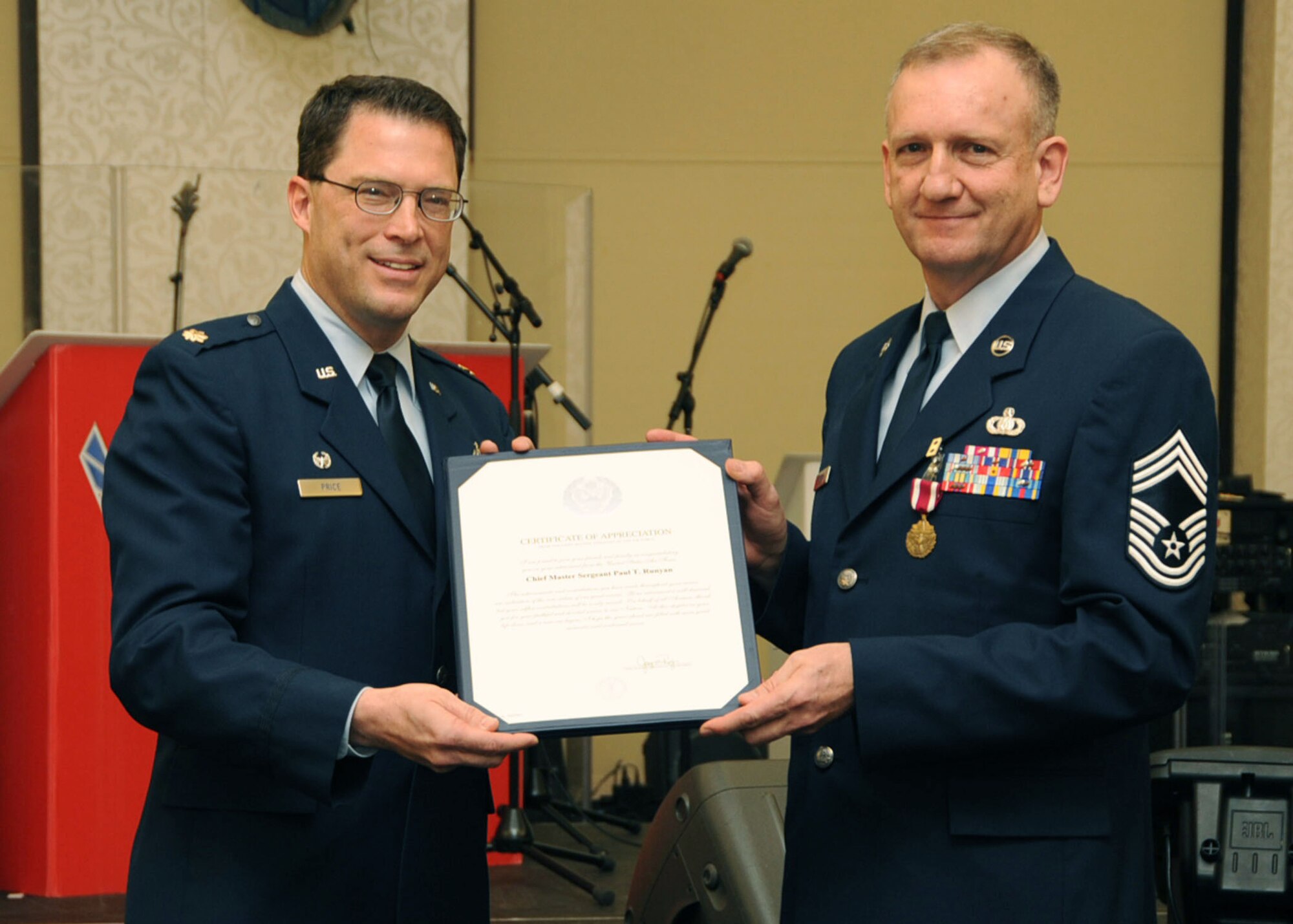 Major Daniel L. Price congratulates Cheif Master Sergeant Paul Runyan at his retirement ceremony