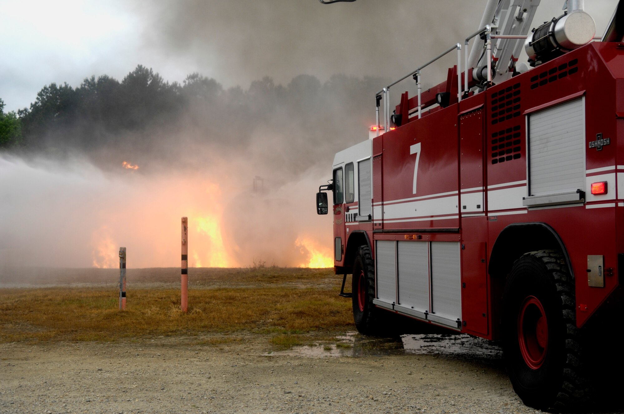 Members from the 628th Civil Engineer squadron extinguish flames from a simulated plane crash on Joint Base Charleston, S.C., May 4, 2010. The crash was part of a Major Accident Response Exercise used to help test and train the supporting agencies who would respond in case of an emergency. (U.S. Air Force Photo/Airman 1st Class Lauren Main)