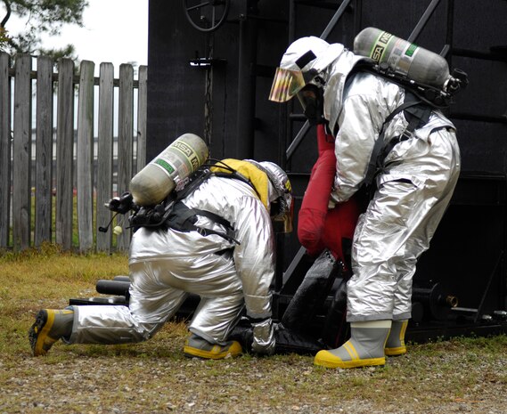 Emergency responders from the 628th Civil Engineer Squadron lift a simulated victim to safety during the Major Accident Response Exercise on Joint Base Charleston, S.C., May 4, 2010. The annual exercise was part of a simulation which included a plane crash. The exercise is used to help test and train the supporting agencies who would respond in case of an emergency. (U.S. Air Force Photo/Airman 1st Class Lauren Main)
