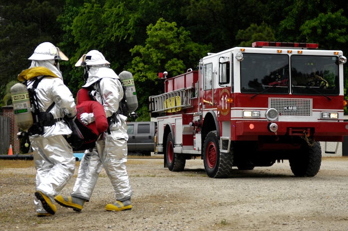 Emergency responders from the 628th Civil Engineer Squadron carry a simulated victim to safety during the Major Accident Response Exercise on Joint Base Charleston, S.C., May 4, 2010. The annual exercise was part of a simulation which included a plane crash. The exercise is used to help test and train the supporting agencies who would respond in case of an emergency. (U.S. Air Force Photo/Airman 1st Class Lauren Main) (U.S. Air Force Photo/Airman 1st Class Lauren Main)