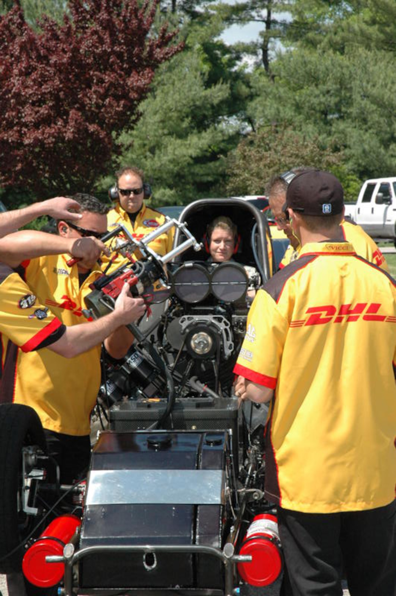 SCOTT AIR FORCE BASE, Ill. -- enior Airman Megan Francolini, 375th Medical Operations Squadron, starts the engine of the DHL funny car April 27 at the Scott Club.  The race car and its driver, Jeff Arend, made an appearance at Scott.  Airman Francolini is the wing's 2009 Junior Enlisted Member of the Year. Courtesy Photo