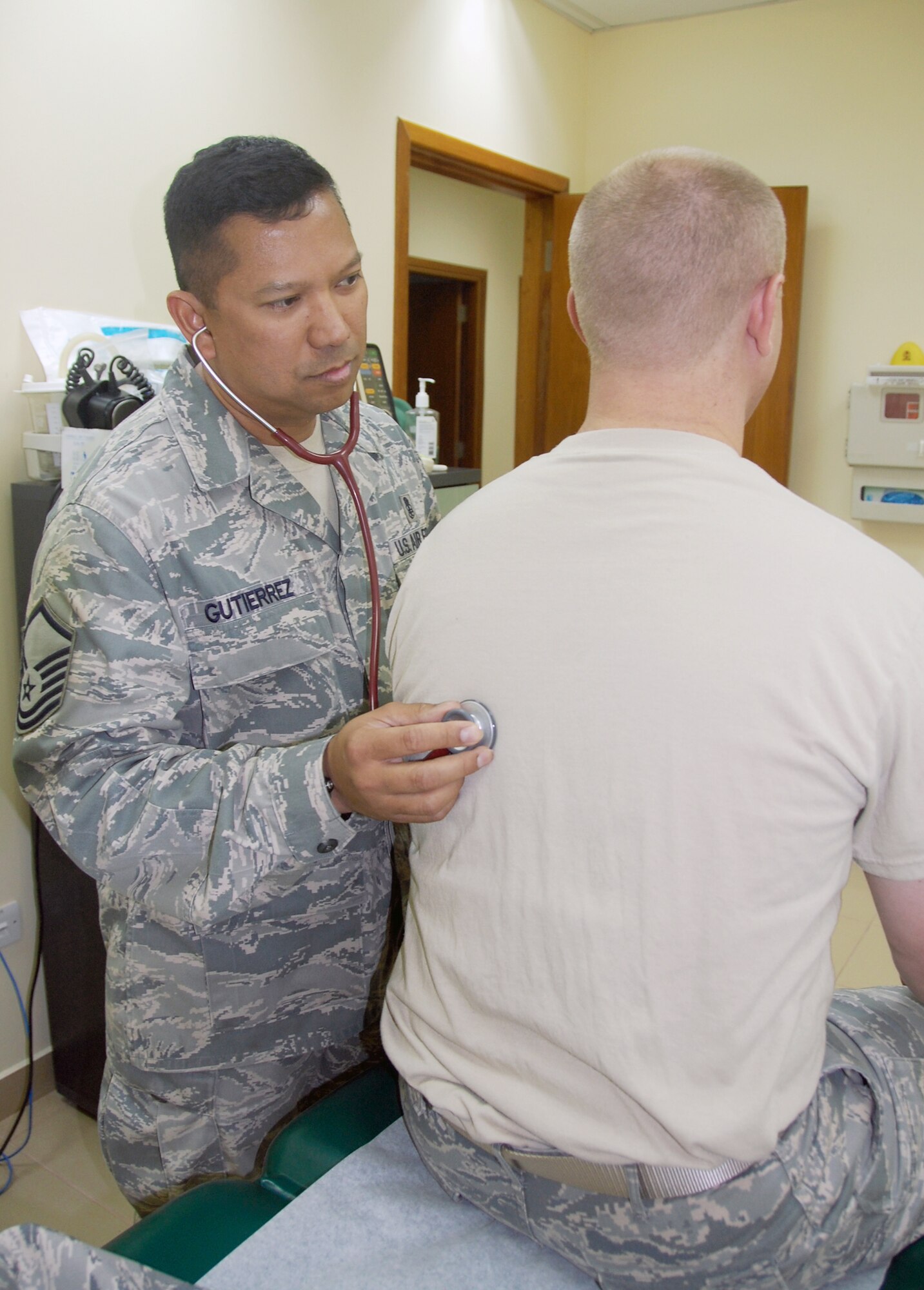 Master Sgt. Roberto Gutierrez, an independent duty medical technician from the 386th Expeditionary Operations Support Squadron, listens to a patient's lungs May 1 at an air base in Southwest Asia. There are fewer than 500 IDMTs in the Air Force and they are often assigned to flying units or organizations in isolated locations to tend to the unit's medical needs. (U.S. Air Force photo/Capt. Joe Campbell)