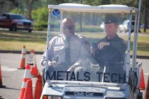 Lt. Col. Matt Young, 916th Safety Office, tries to maneuver an obstacle course while he works the text messaging function on his phone. A state highway patrolman gives him the rules of the road during this 916th Safety Day obstacle course. (USAF photo by Maj. Shannon Mann, 916ARW/PA)