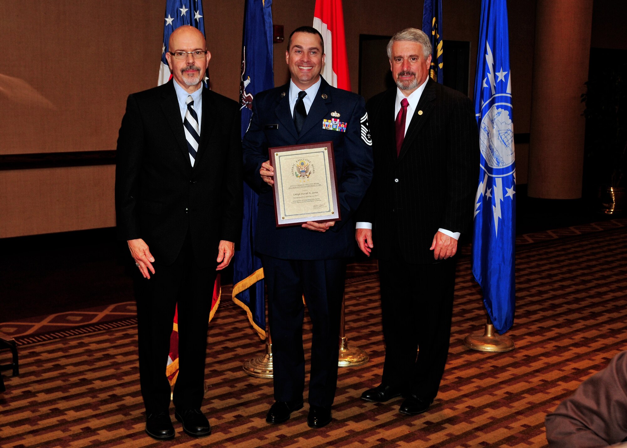 U.S. Air Force Senior Master Sgt. David A. Leone, 914th Airlift Wing (center) receives the Distinguished Government Service Award, May 4, 2010, Buffalo NY. The Buffalo Federal Executive Board Excellence in Government luncheon celebrating excellence in public service was held in the Buffalo convention center. (U.S. Air Force photo by Staff Sgt. Joseph McKee)