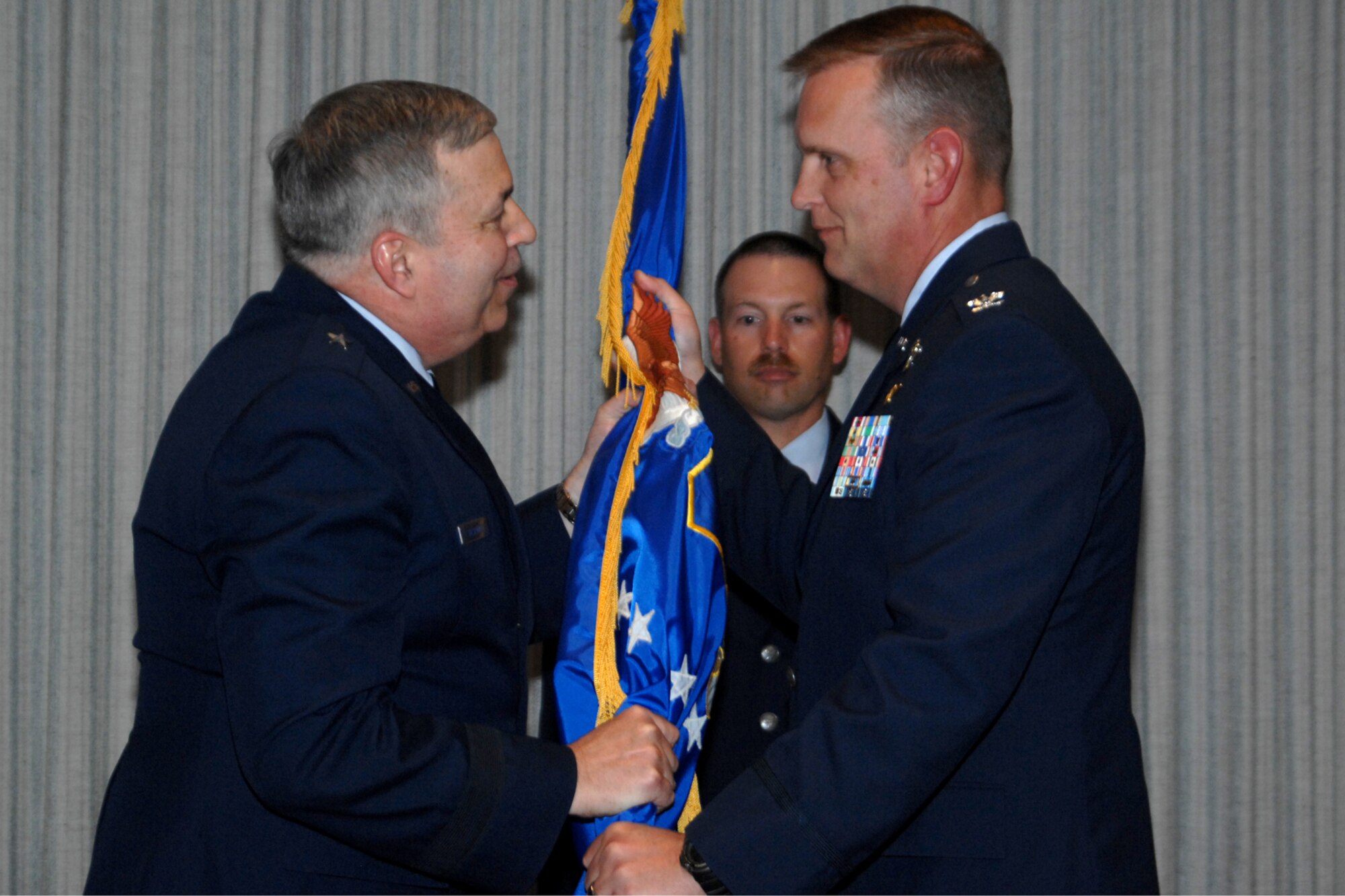 GRISSOM AIR RESERVE BASE, Ind., -- Brig. Gen. Dean Despinoy, 434th Air Refueling Wing commander, left, passes the 434th Operations Group flag to Col. William Mason, as he assumes command. Colonel Mason assumed command from Col. Randall Ogden, who transferred to Seymour-Johnson AFB, N.C. (U.S. Air Force photo/Tech. Sgt. Doug Hays)