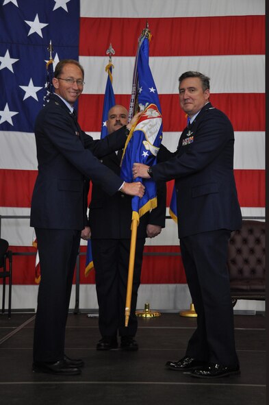 Col. Darrell G. Young(right) accepts the 934th Airlift Wing flag from Maj. Gen. James T. Rubeor, 22nd Air Force Commander, and assumes command of the Wing during a ceremony here May 2. (Air Force Photo/Tech. Sgt. Bob Sommer)