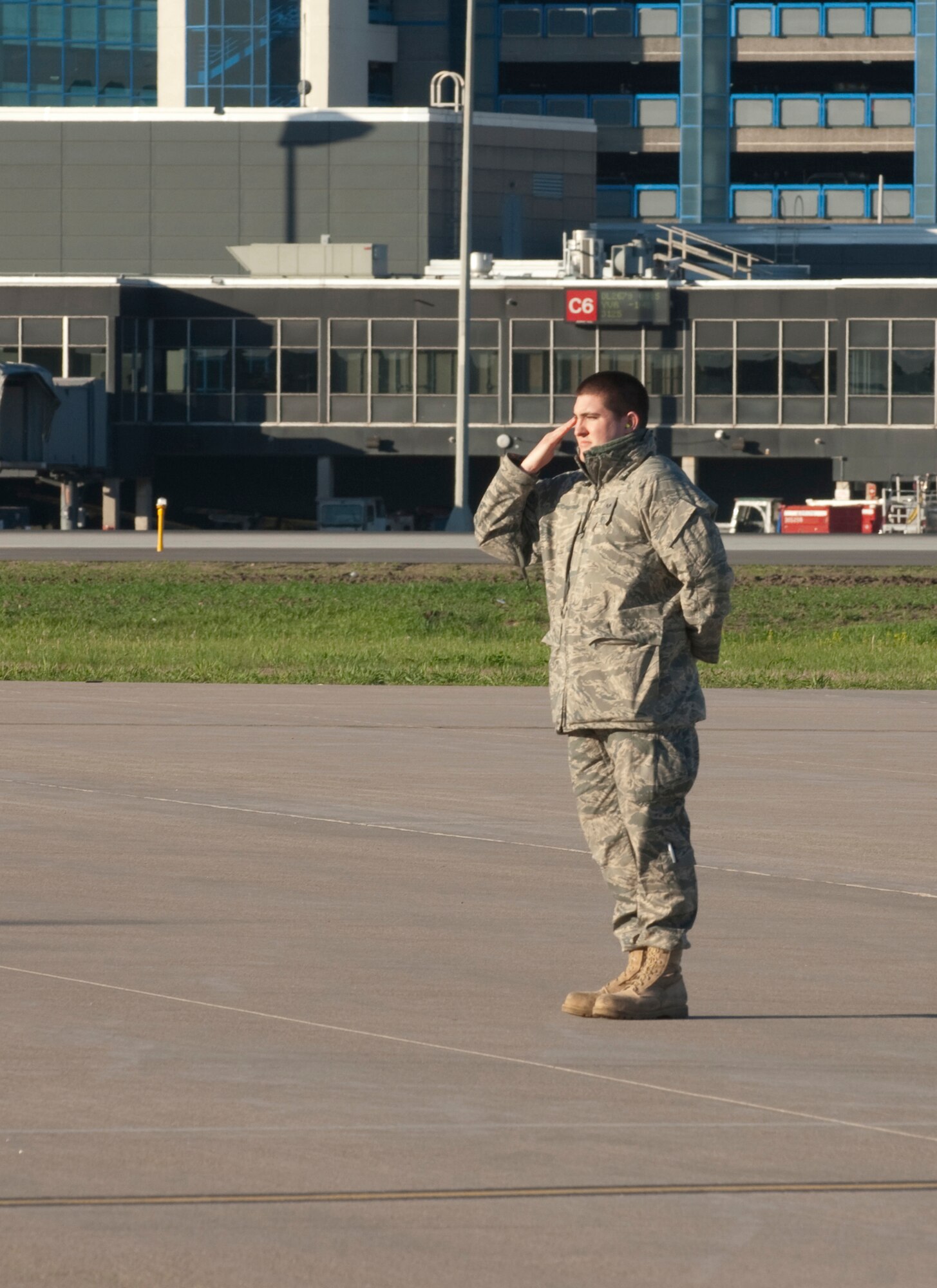 A crew chief from the Minnesota Air National Guard snaps a salute to the Airmen aboard a C-130 "Hercules" cargo aircraft as they launch from the Minneapolis St. Paul International Airport on May 1, 2010.  Minnesota Airmen from the St. Paul Air National Guard base are deploying to Southwest Asia in support of Operation Enduring Freedom. USAF photo by Senior Master Sgt. Mark Moss (Released)