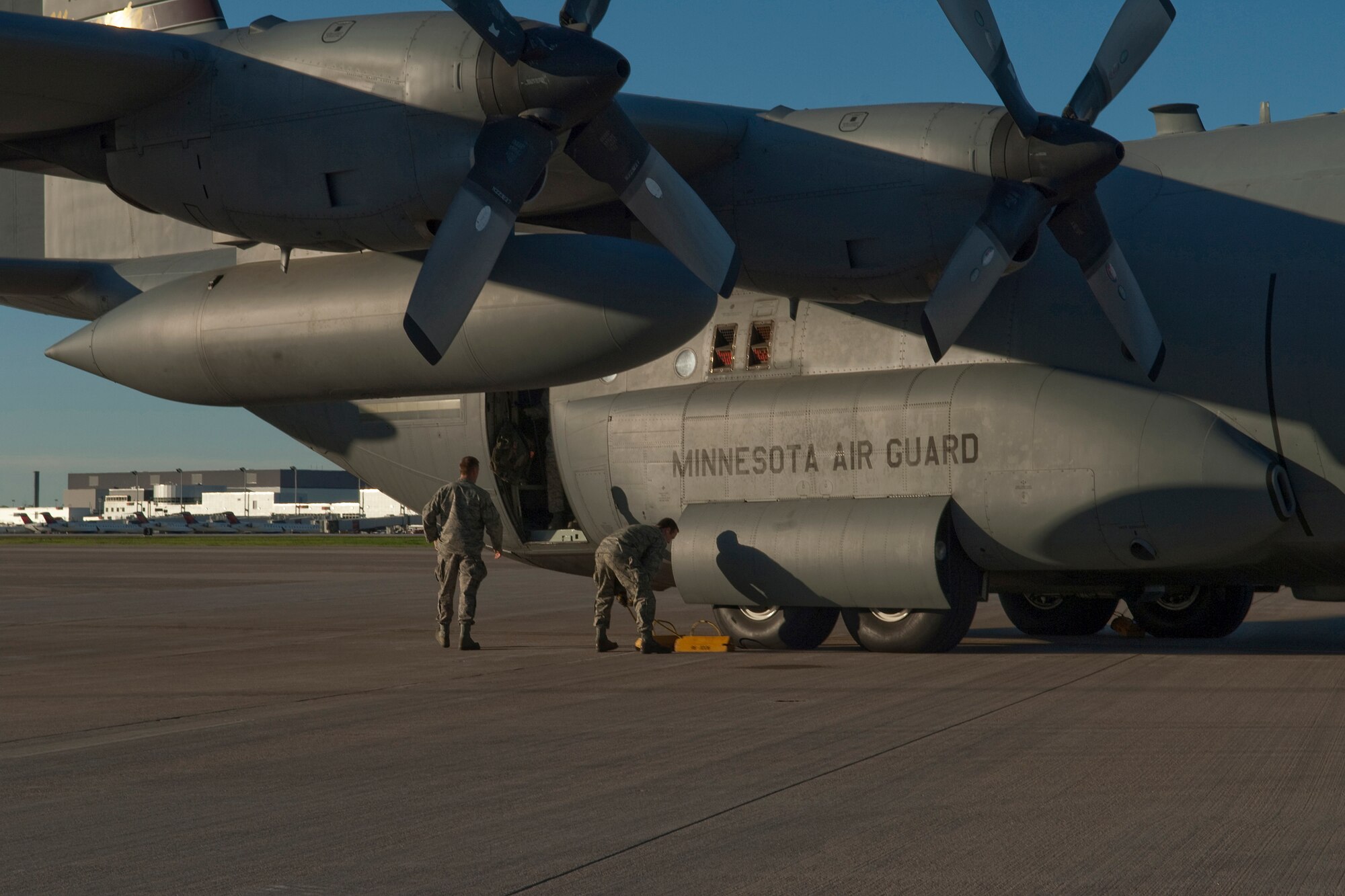 Crew chiefs pull the chocks from under the wheels of a C-130 "Hercules" cargo aircraft on May 1, 2010 as they prepare to launch on a deployment to Southwest Asia.  Minnesota Airmen from the St. Paul Air National Guard base will be transporting troops and supplies supporting Operation Enduring Freedom. USAF photo by Senior Master Sgt. Mark Moss (Released)