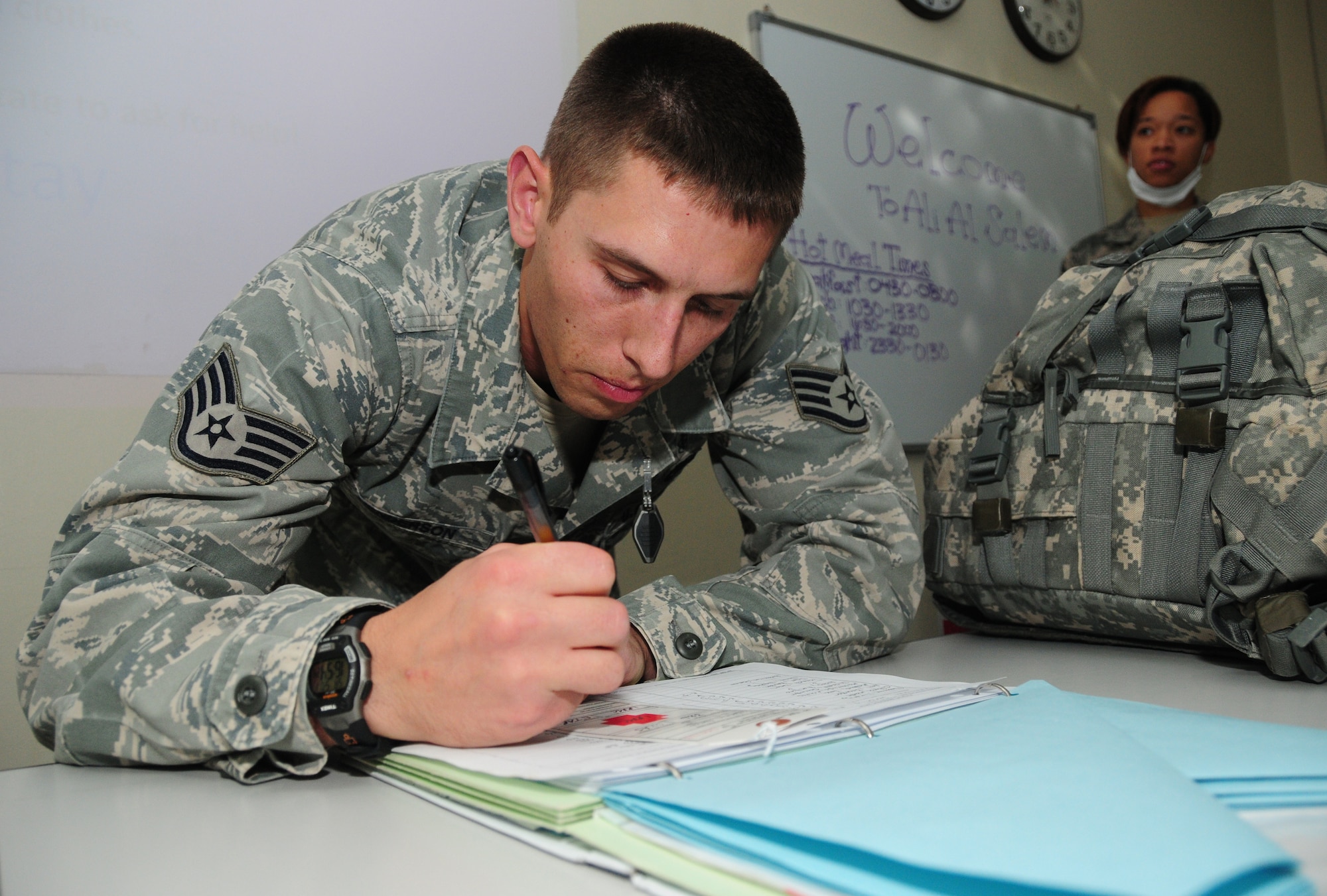 U.S. Air Force Staff Sgt. Chris Henderson, 386th Expeditionary Medical Group medical technician, processes patients into the contingency aeromedical staging facility May 1, 2010 at an air base in Southwest Asia. (U.S. AIr Force photo by Staff Sgt. Lakisha A. Croley/Released)